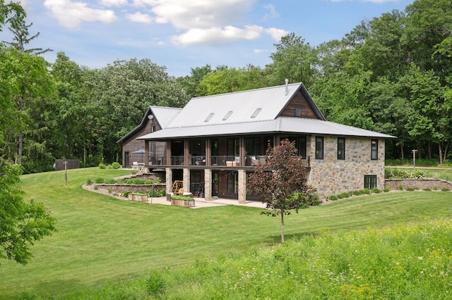 1701 Retreat Cir, Minnetrista, MN 55364 - back of property with stone siding, a patio area, and a lawn