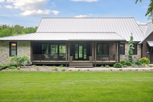 1701 Retreat Cir, Minnetrista, MN 55364 - back of house featuring a standing seam roof, stone siding, and a yard