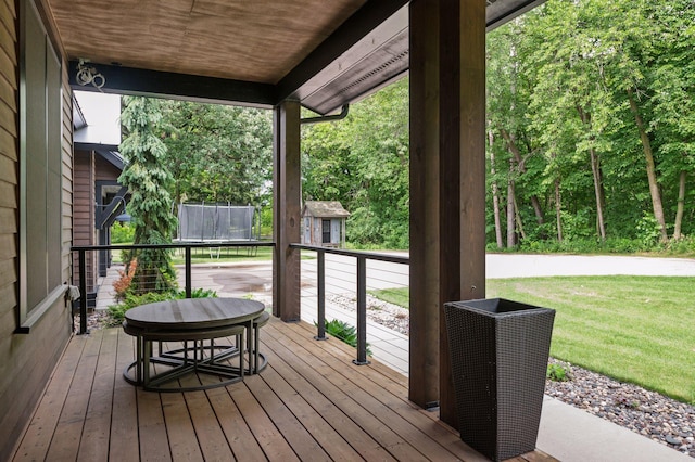 1701 Retreat Cir, Minnetrista, MN 55364 - wooden terrace featuring a storage shed, a yard, and a trampoline