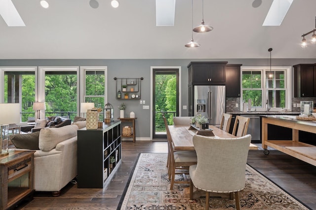 1701 Retreat Cir, Minnetrista, MN 55364 - dining room featuring a skylight, vaulted ceiling, and dark wood-type flooring