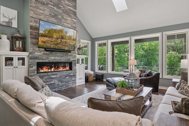 1701 Retreat Cir, Minnetrista, MN 55364 - living area with wood finished floors, a stone fireplace, healthy amount of natural light, a skylight, and high vaulted ceiling
