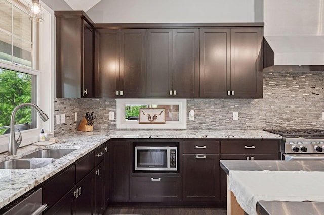 1701 Retreat Cir, Minnetrista, MN 55364 - kitchen featuring stainless steel appliances, wall chimney range hood, dark brown cabinetry, and decorative backsplash