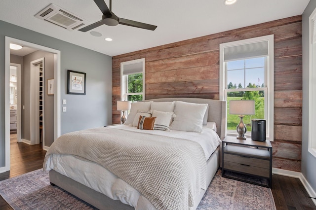 1701 Retreat Cir, Minnetrista, MN 55364 - bedroom with wooden walls, a spacious closet, wood finished floors, recessed lighting, and a ceiling fan