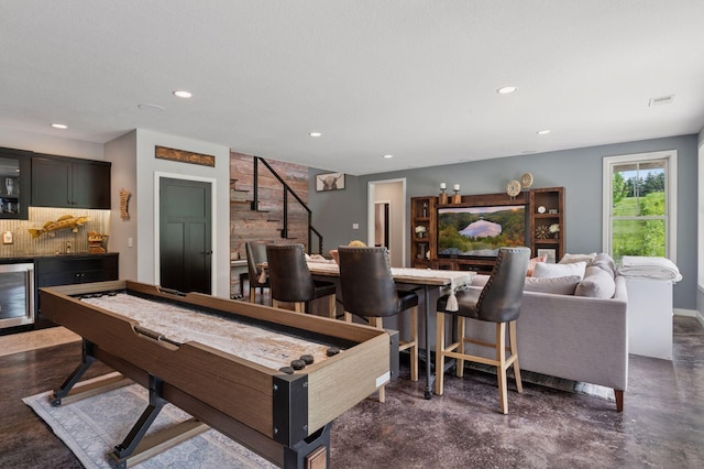 1701 Retreat Cir, Minnetrista, MN 55364 - playroom with bar with sink, beverage cooler, recessed lighting, and concrete flooring