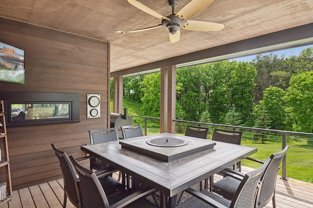 1701 Retreat Cir, Minnetrista, MN 55364 - wooden deck with outdoor dining space, a ceiling fan, and a yard