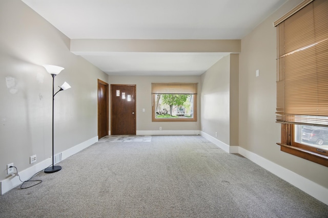 733 1st St SW, Faribault, MN 55021 - unfurnished living room featuring carpet floors and baseboards