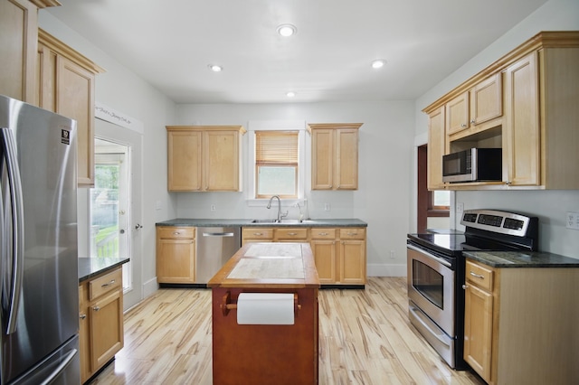 733 1st St SW, Faribault, MN 55021 - kitchen featuring appliances with stainless steel finishes, light brown cabinets, a sink, light wood-type flooring, and recessed lighting