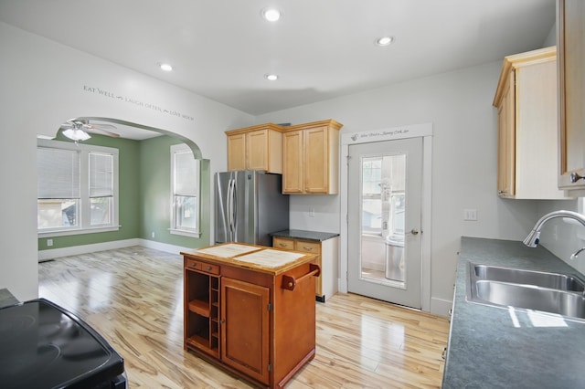 733 1st St SW, Faribault, MN 55021 - kitchen with freestanding refrigerator, light wood-type flooring, a sink, black range with electric stovetop, and recessed lighting