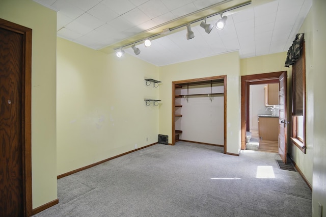 733 1st St SW, Faribault, MN 55021 - unfurnished bedroom with track lighting, carpet flooring, a closet, and baseboards