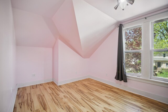 733 1st St SW, Faribault, MN 55021 - bonus room featuring lofted ceiling, light wood-type flooring, baseboards, and a ceiling fan