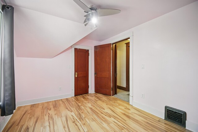 733 1st St SW, Faribault, MN 55021 - additional living space with a ceiling fan, light wood-style floors, and baseboards