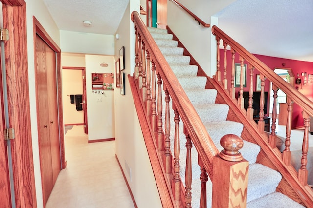 127 County Rd W, Pleasant Valley Twp, WI 54022 - stairs with a textured ceiling and tile patterned floors