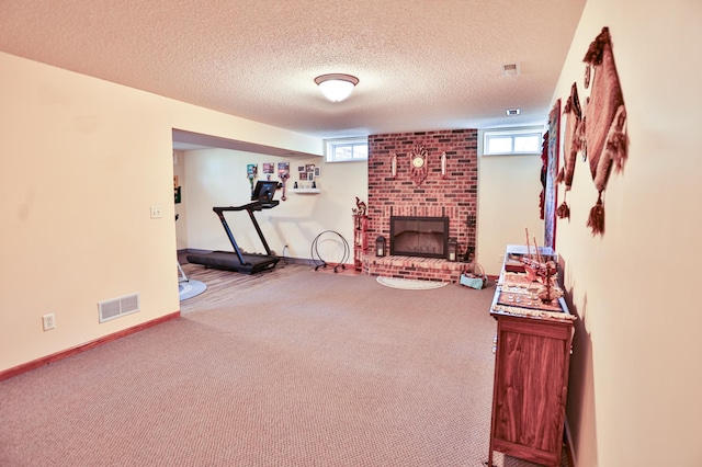 127 County Rd W, Pleasant Valley Twp, WI 54022 - exercise area featuring a fireplace, carpet flooring, a textured ceiling, and baseboards