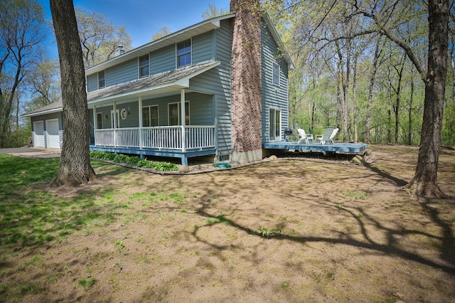 127 County Rd W, Pleasant Valley Twp, WI 54022 - view of side of property featuring a porch, an attached garage, and a chimney