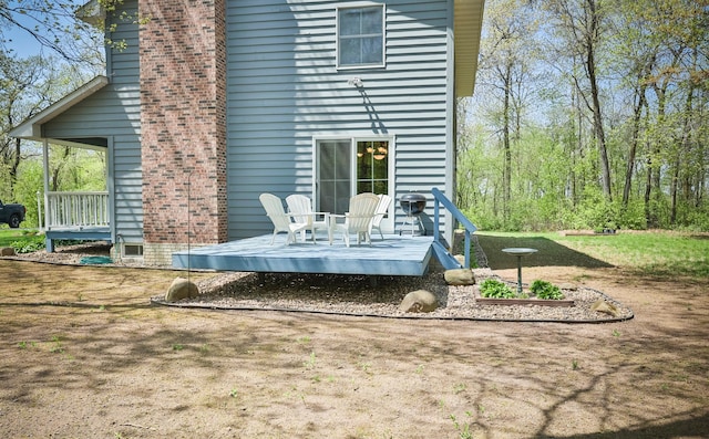 127 County Rd W, Pleasant Valley Twp, WI 54022 - back of property with a wooden deck and a chimney