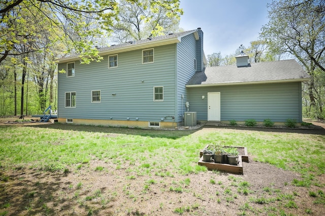 127 County Rd W, Pleasant Valley Twp, WI 54022 - back of property featuring a chimney, a vegetable garden, a lawn, and cooling unit