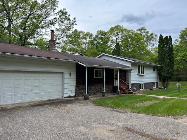 25622 Blue Bonnet Rd, Center Twp, MN 56465 - tri-level home with a garage, driveway, a front yard, and a chimney