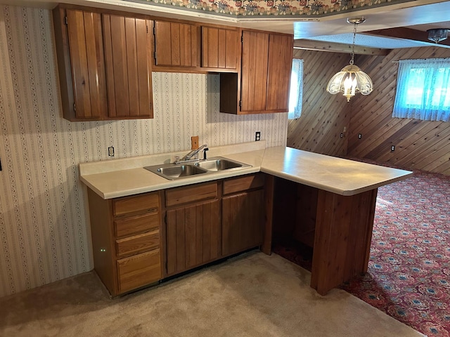 25622 Blue Bonnet Rd, Center Twp, MN 56465 - kitchen featuring a sink, light carpet, brown cabinetry, light countertops, and decorative light fixtures