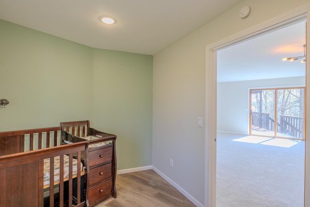 bedroom featuring baseboards and wood finished floors