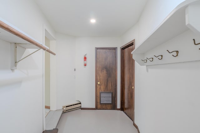 mudroom featuring baseboard heating, concrete flooring, and recessed lighting