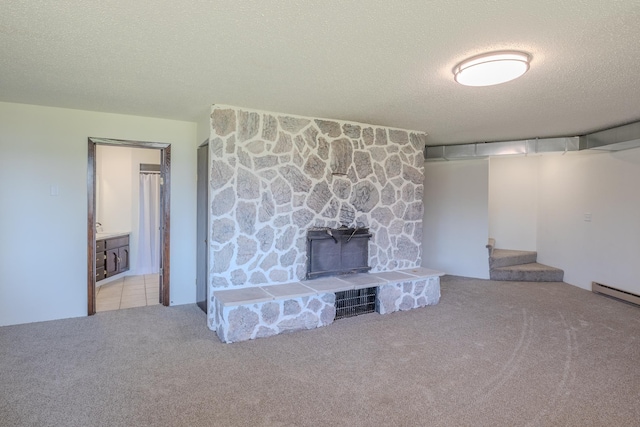 unfurnished living room featuring carpet floors, a textured ceiling, and stairs
