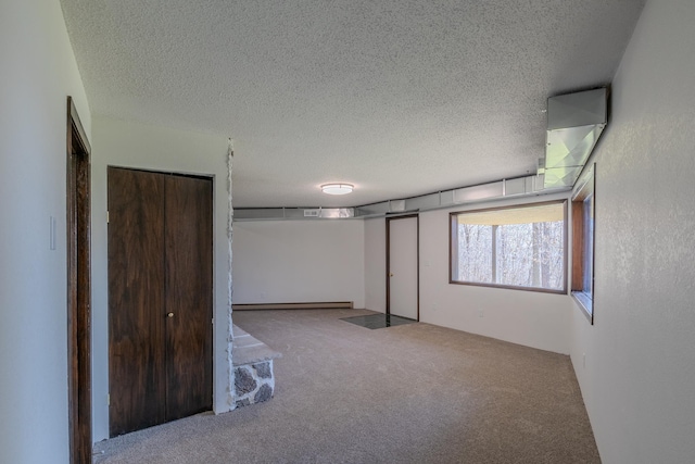 unfurnished bedroom with carpet floors and a textured ceiling