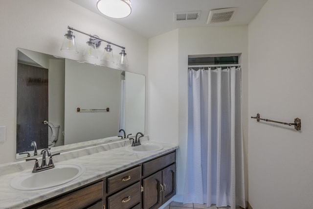 bathroom with double vanity, toilet, and a shower with curtain
