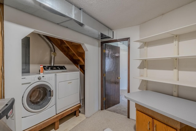 washroom with washing machine and clothes dryer, light carpet, and electric panel
