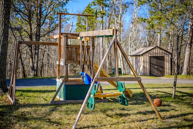 view of play area with a lawn and an outbuilding