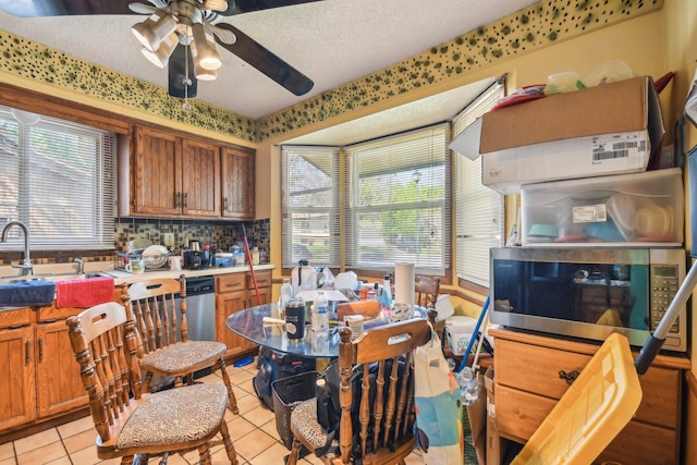 6522 Kilmer Ln N, Maple Grove, MN 55369 - kitchen with a sink, light tile patterned floors, ceiling fan, brown cabinets, and a textured ceiling