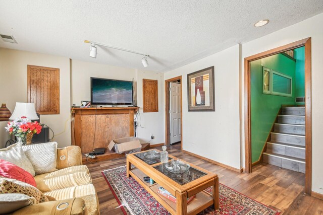 6522 Kilmer Ln N, Maple Grove, MN 55369 - living area with wood finished floors, a textured ceiling, stairway, and baseboards