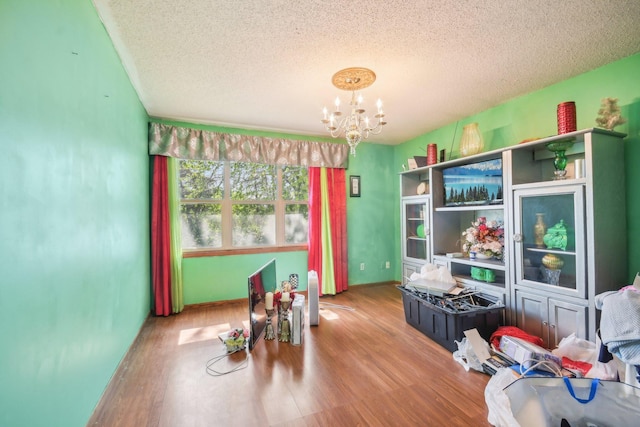 6522 Kilmer Ln N, Maple Grove, MN 55369 - misc room featuring a textured ceiling, a chandelier, and wood finished floors