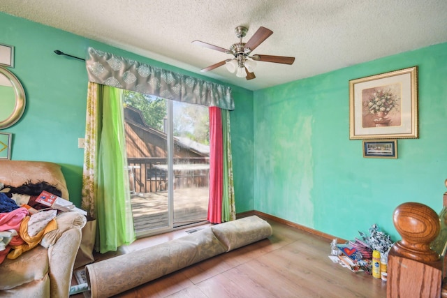 6522 Kilmer Ln N, Maple Grove, MN 55369 - sitting room with a ceiling fan, a textured ceiling, and wood finished floors