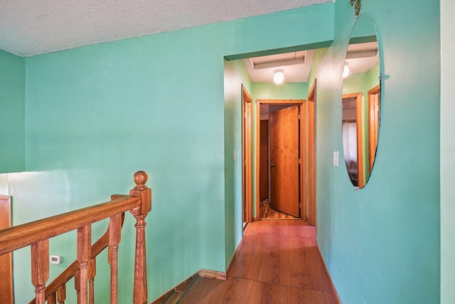 6522 Kilmer Ln N, Maple Grove, MN 55369 - corridor featuring wood finished floors, an upstairs landing, a textured ceiling, and baseboards