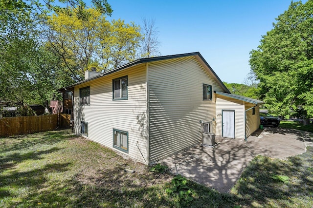 6522 Kilmer Ln N, Maple Grove, MN 55369 - view of property exterior with a chimney, a patio, and central AC unit