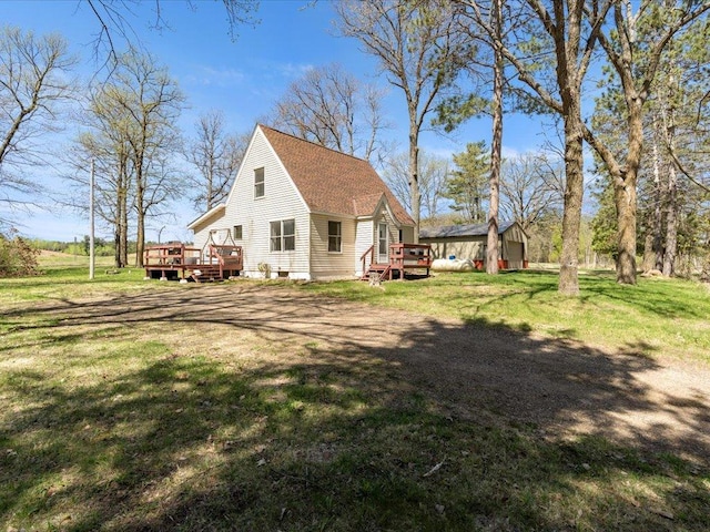 15921 Eaglewood Dr, Bay Lake Twp, MN 56444 - view of home's exterior with a deck, a yard, and a shingled roof