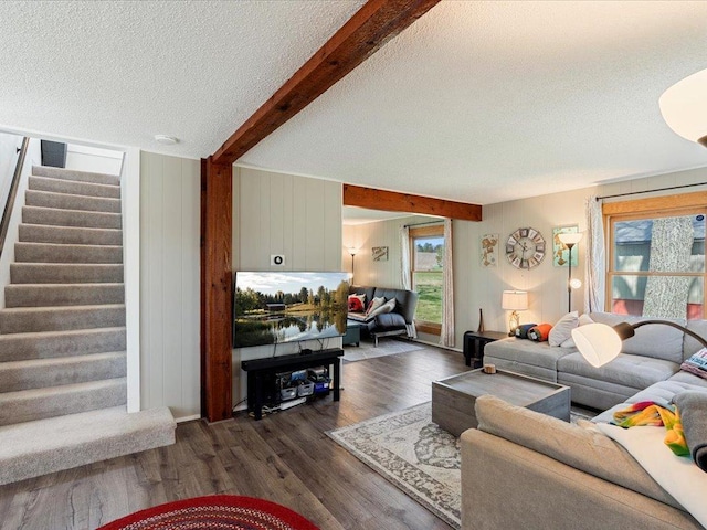 15921 Eaglewood Dr, Bay Lake Twp, MN 56444 - living room featuring a textured ceiling, beam ceiling, stairway, dark wood finished floors, and healthy amount of natural light