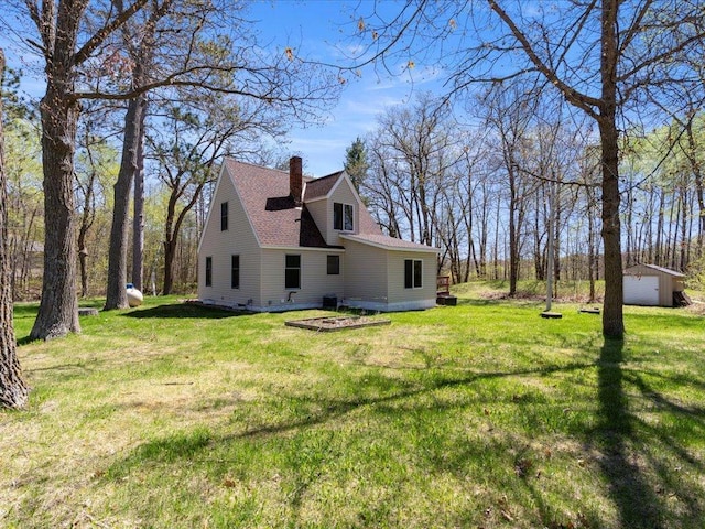 15921 Eaglewood Dr, Bay Lake Twp, MN 56444 - view of side of home with a chimney, a yard, and an outdoor structure