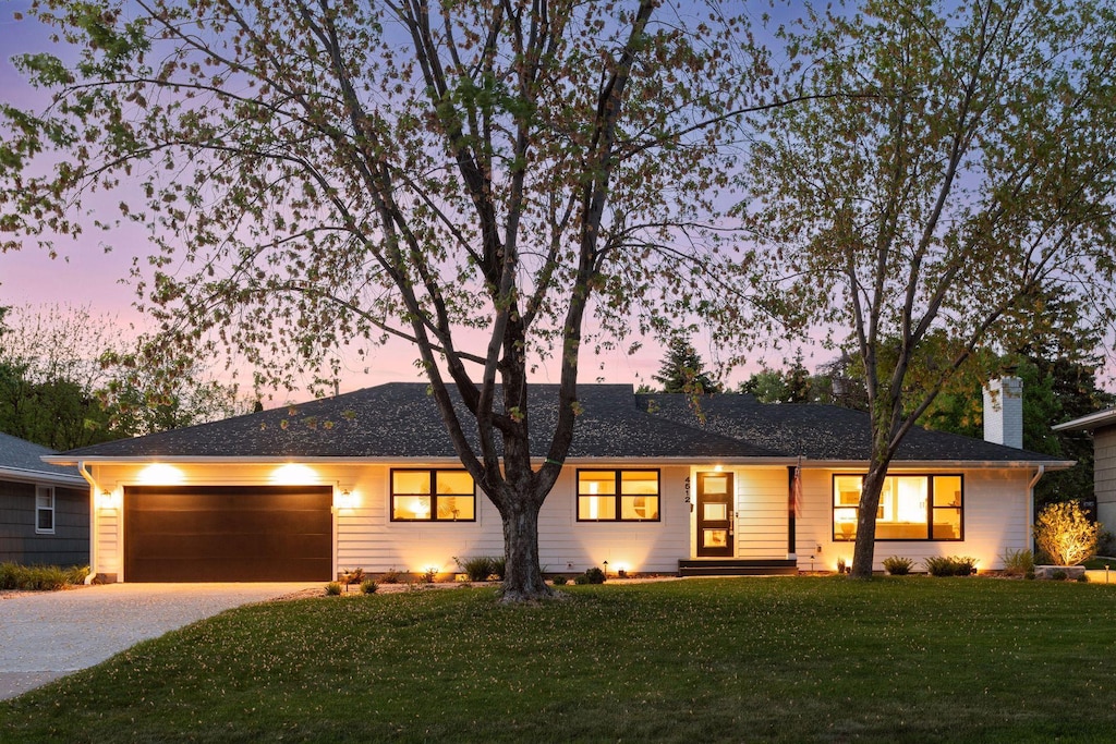4512 Andover Rd, Edina, MN 55435 - ranch-style house featuring concrete driveway, a lawn, a garage, and a chimney