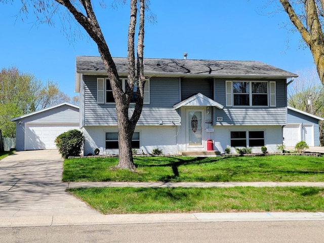 bi-level home with brick siding, a garage, and a front lawn