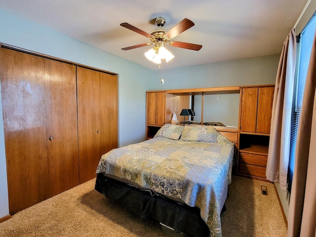 bedroom with light carpet, a closet, and ceiling fan
