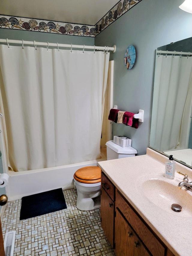 full bathroom with toilet, vanity, and shower / tub combo