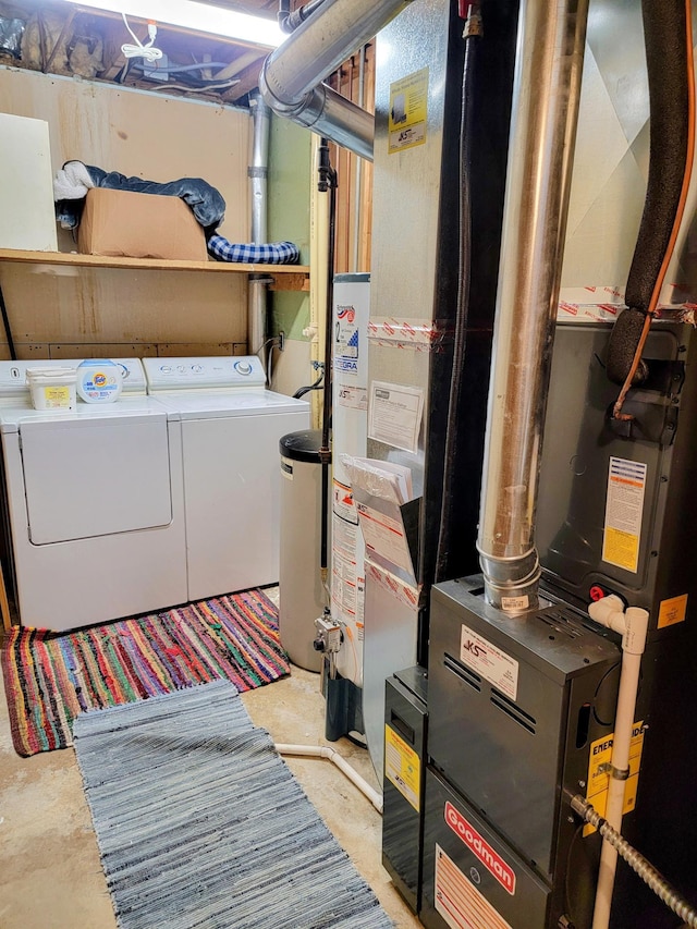 laundry room featuring washer and dryer, heating unit, and water heater