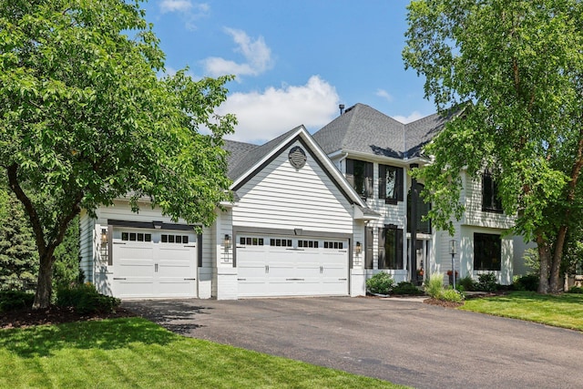 4255 Wexford Way, Eagan, MN 55122 - view of front of house featuring asphalt driveway, a garage, a front yard, and roof with shingles