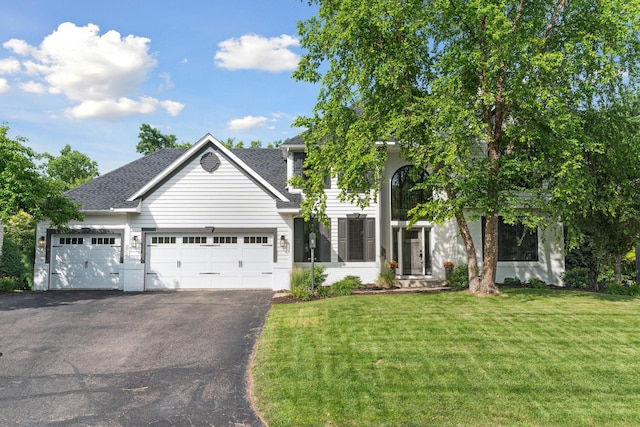 4255 Wexford Way, Eagan, MN 55122 - view of front of house featuring asphalt driveway, a front lawn, an attached garage, and a shingled roof