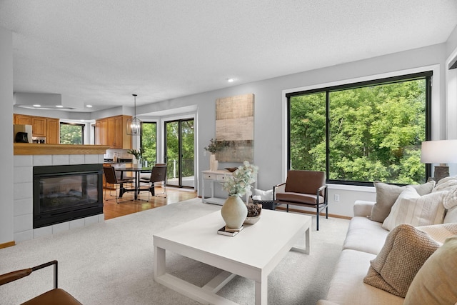 4255 Wexford Way, Eagan, MN 55122 - living area featuring recessed lighting, a textured ceiling, light colored carpet, and a tiled fireplace