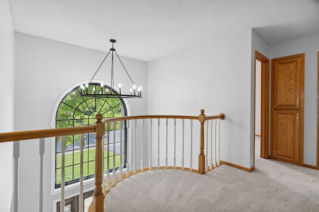 4255 Wexford Way, Eagan, MN 55122 - corridor with healthy amount of natural light, an upstairs landing, a chandelier, carpet, and a textured ceiling
