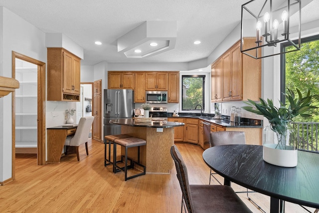 4255 Wexford Way, Eagan, MN 55122 - kitchen featuring stainless steel appliances, dark countertops, light wood-style flooring, plenty of natural light, and recessed lighting