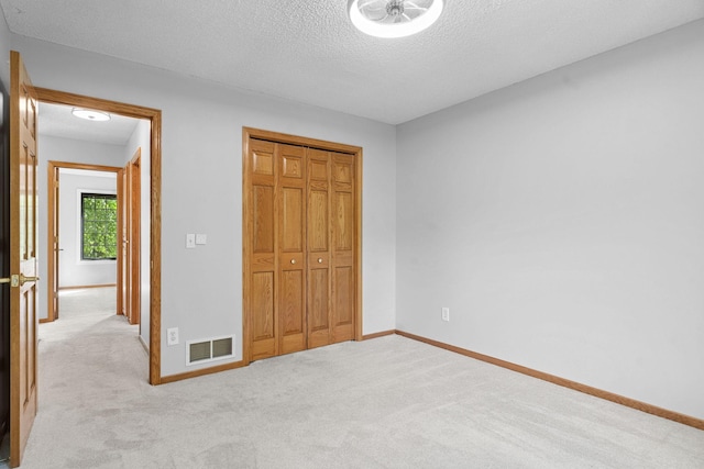 4255 Wexford Way, Eagan, MN 55122 - unfurnished bedroom with light colored carpet, a textured ceiling, and a closet