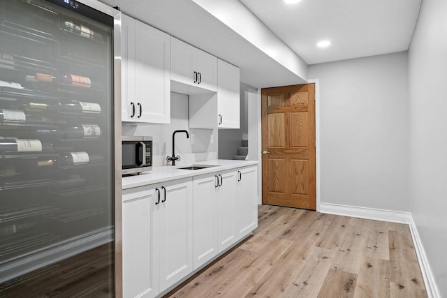 4255 Wexford Way, Eagan, MN 55122 - kitchen featuring fridge, stainless steel microwave, light wood finished floors, white cabinetry, and light countertops